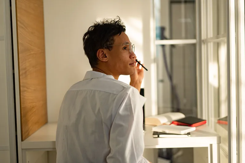 A founder staring out a window, reflecting — the moment between hearing friendly feedback and realizing it may not mean what you hoped