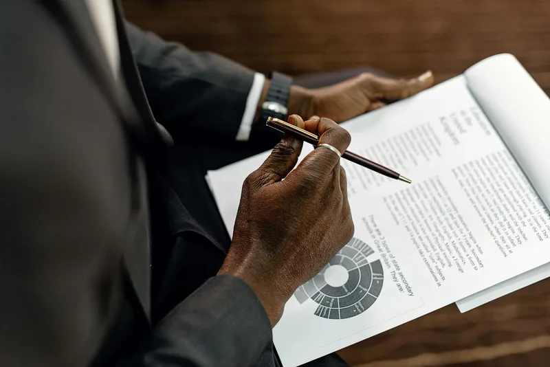 A solopreneur reviewing a scorecard on paper with a go, wait, or kill decision column visible