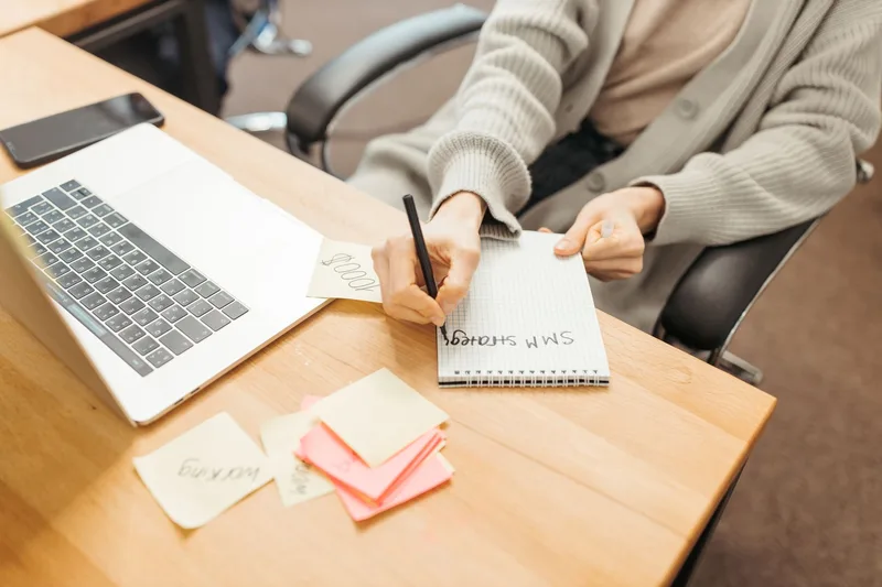 A person on a video call with a notepad, conducting a customer discovery conversation before committing to building a product