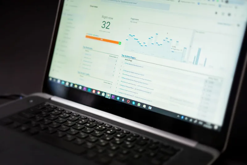 A laptop screen showing a website analytics dashboard with minimal traffic and an empty signups counter