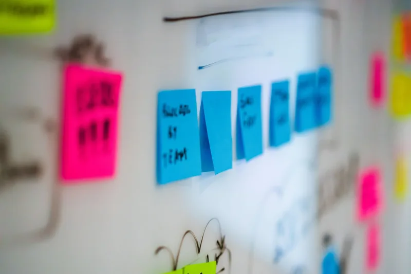 A person mapping target buyer profiles and situation triggers on a planning board with sticky notes