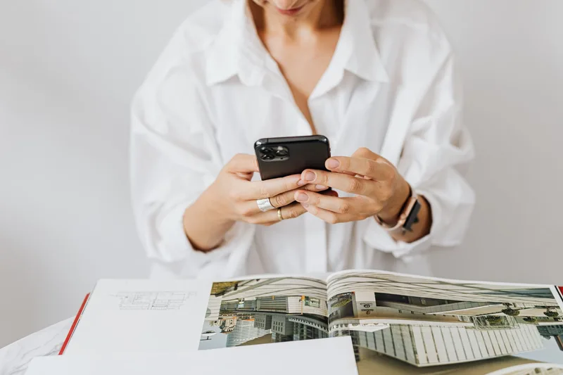 A person reading their phone while viewing social media engagement and comments